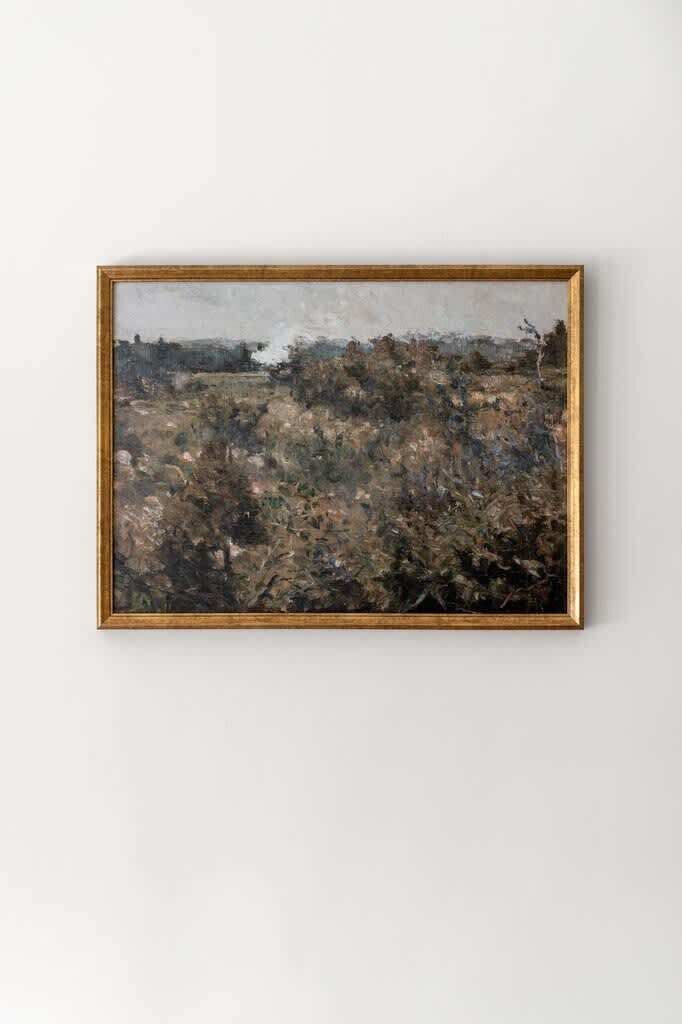 Quadro emoldurado mostrando uma paisagem com árvores e um edifício ao longe.