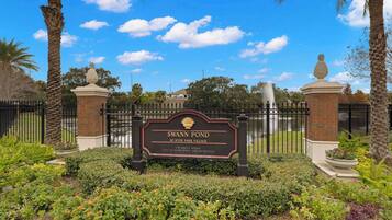 A sign for Swann Pond at Hyde Park Village, indicating its location at 179 Swann Avenue, City of Toronto Parks and Recreation.