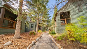 A pathway leading to a row of wooden houses with a number sign '1911' visible. - Updated Condo w/Covered Deck & Great Views! (Keystone)