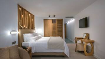 A modern bedroom with a bed, bedside table, and a wooden wardrobe.