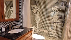 A bathroom with a checkered tile backsplash, a sink with a black countertop, wooden cabinets, and a toilet. - Edge Point Voice Intelligent Hotel (Chongqing)