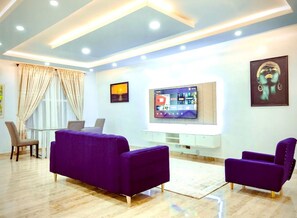 Standard Apartment | Living area | 8-inch TV with satellite channels - Amara Suites Lekki (Lagos)
