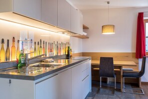 Fridge, stovetop, dishwasher, coffee/tea maker