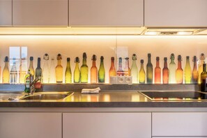 Fridge, stovetop, dishwasher, coffee/tea maker