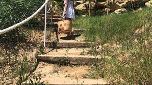 A person walking up a stone staircase surrounded by greenery and rocks. - Holiday Apartment "Capo Rizzuto 2" with Sea View, Private Terrace & Wi-Fi (isola di capo rizzuto)