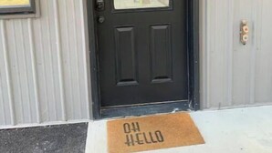 A black door with a wreath, a doormat with "HELLO" on it, and a window to the left. - Luxury shome, views above Skagit Valley- EV charge (Mount Vernon)
