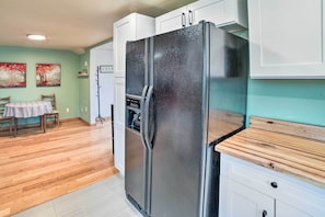 Compact kitchen with a dining table and chairs, perfect for meals and relaxation.