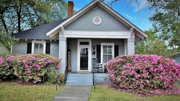 A two-story house with a front porch, a chimney, and a mailbox. - Charming and cozy home by a Historic District (Columbus)