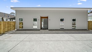 A single-story building with a flat roof, a front door, and two windows on each side. - Contemporary Comfort - Masterton Holiday Home (Masterton)