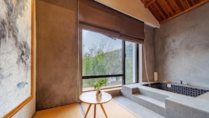 A modern bathroom with a large window, a bathtub, and a small table with a plant. - Hmyway (Dali City)