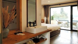 A modern bedroom with a large window, a bedside table with a mirror, a white sink, and a bed. - Hmyway (Dali City)