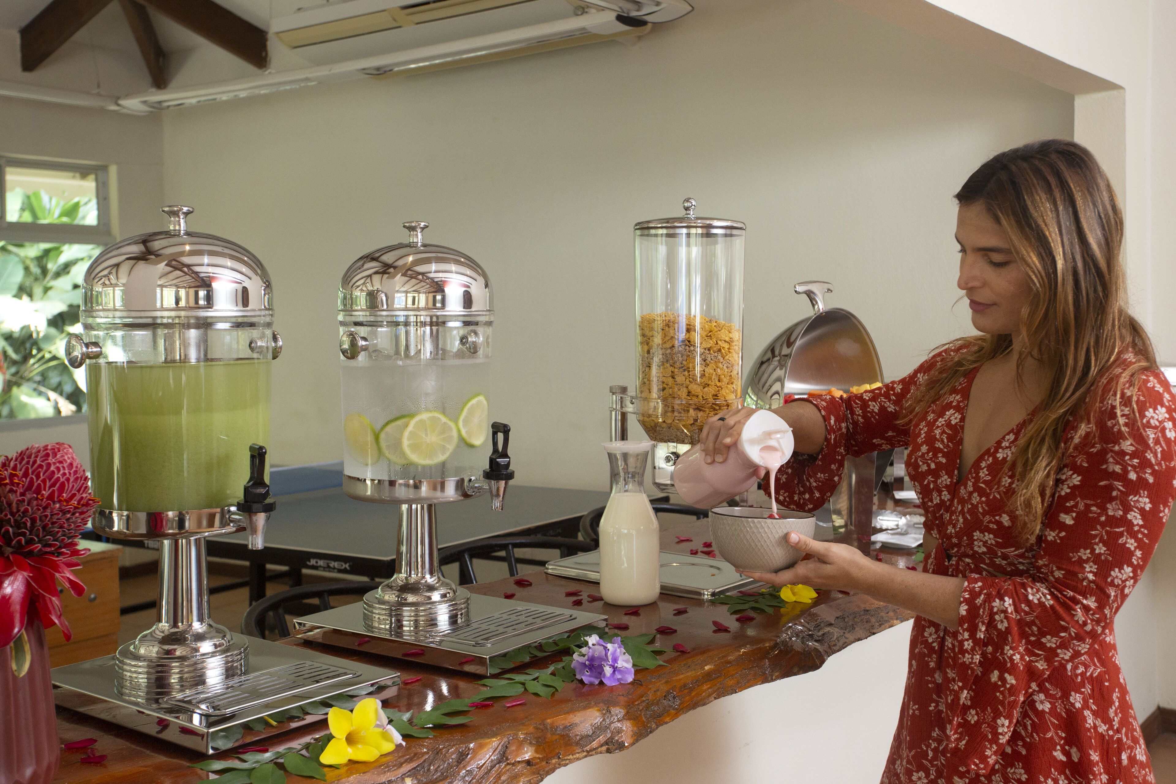 A person preparing a drink at a bar with various equipment and ingredients.