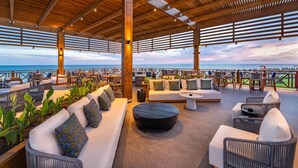 A covered outdoor seating area with wicker furniture and a view of the sea. - Rixos Park Belek - All Inclusive - The Land of Legends Access (Serik)