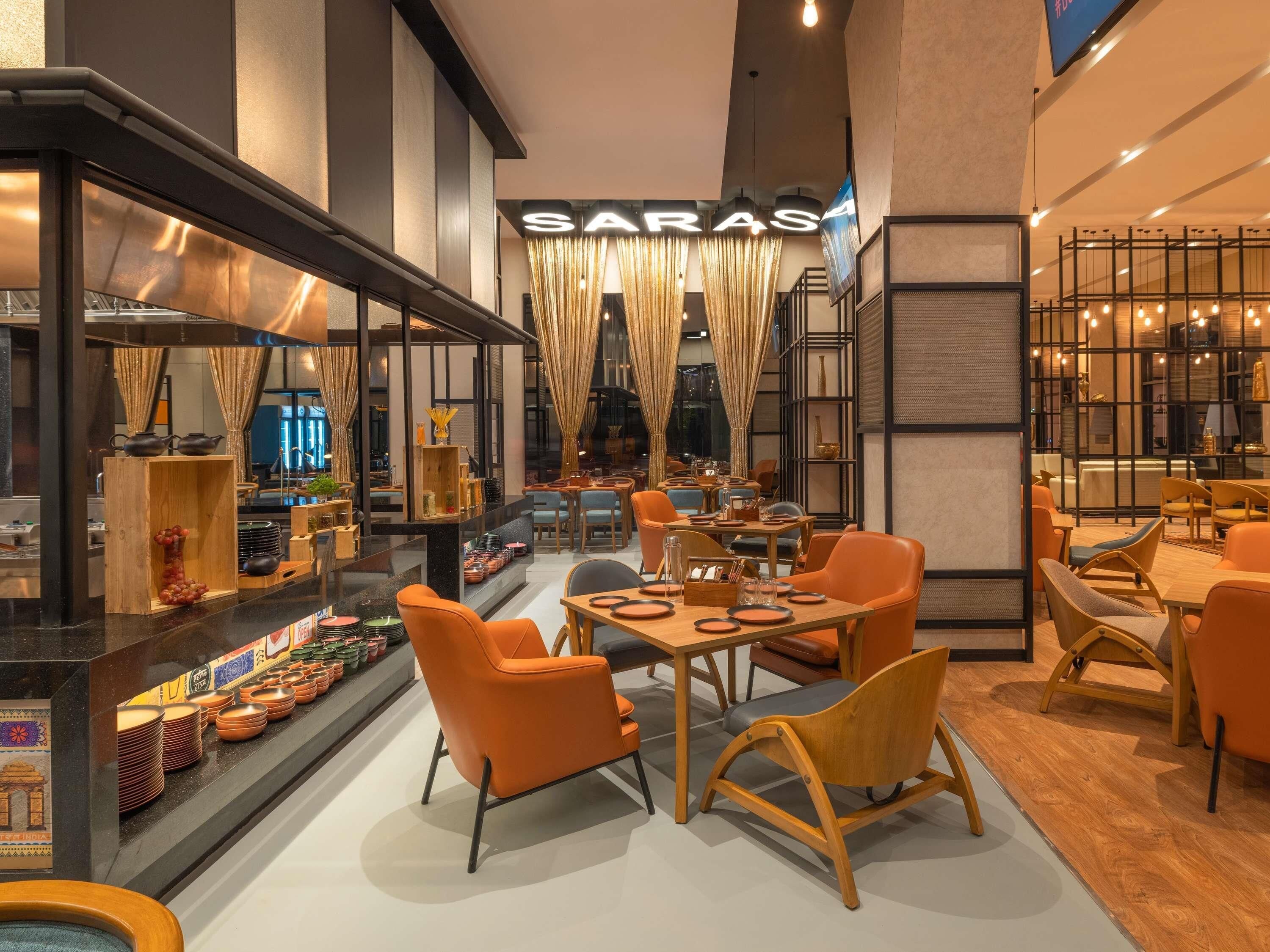 A restaurant interior with a bar area, seating arrangements, and a sign reading 'SARAS.'