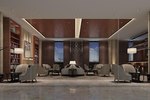 A modern lobby with a central seating area, bookshelves, and large windows. - Wisconsin Spa Hotel (Tianjin)