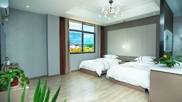 A modern hotel room with two beds, a large window, a ceiling light, and a plant.