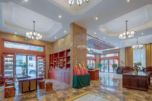 A spacious lobby with a marble floor, a reception desk, and a large chandelier. - Hengshan Hotel (Hengshan County)