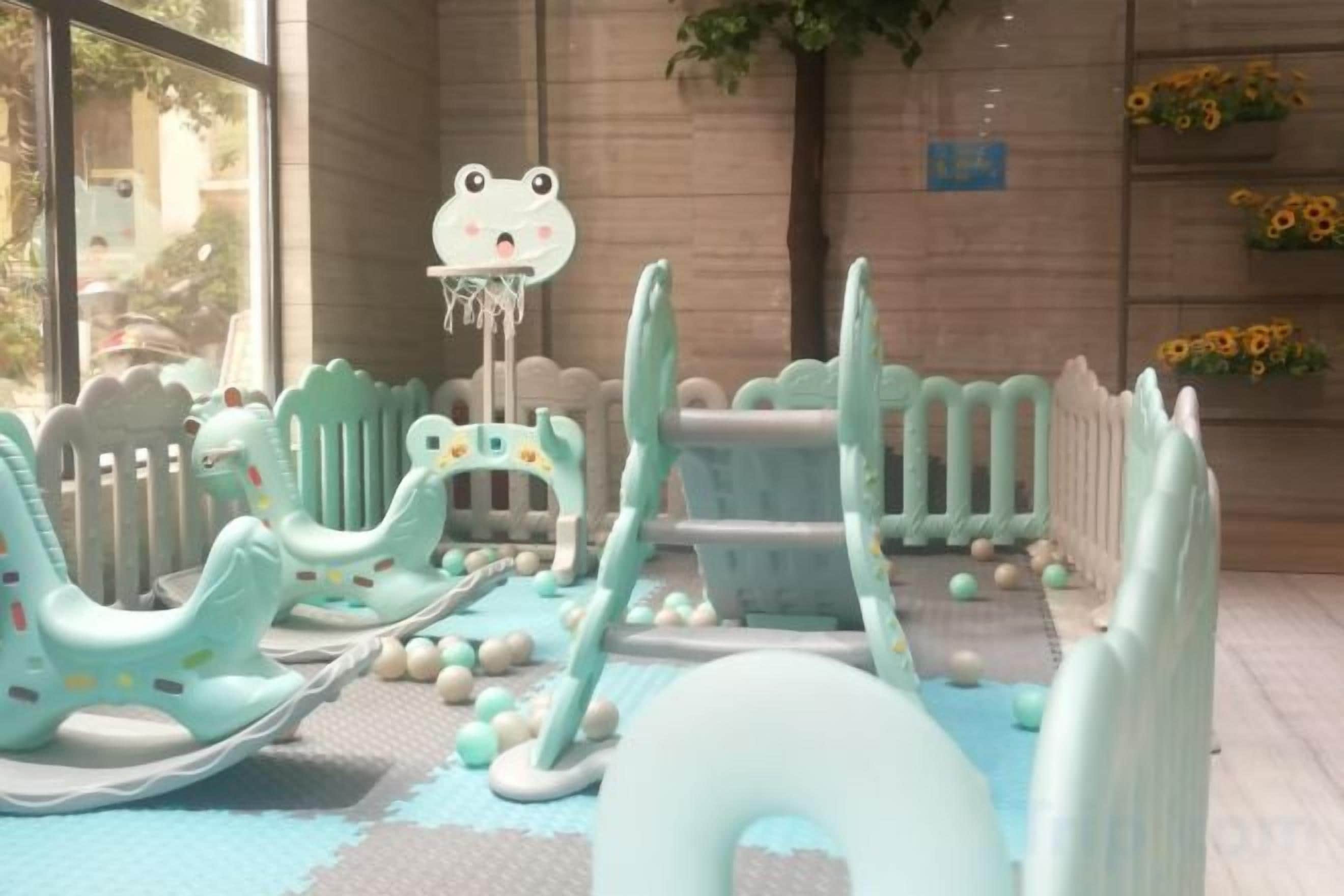 Un'area giochi con strutture in gomma e una decorazione a forma di rana.