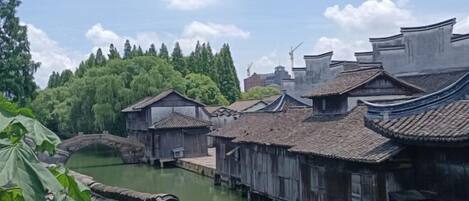 Traditional wooden buildings with a river and a bridge.