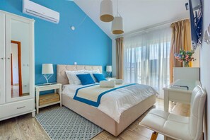 A modern hotel room with a large bed, a desk, a chair, and a wardrobe. - Villa Belleza - sea views, heated pool, 70m to the beach by MyWaycation (Rogoznica)