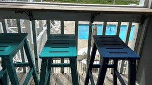 A wooden deck with a pool and beach view. - Sea La Vie (Ocean Isle Beach)