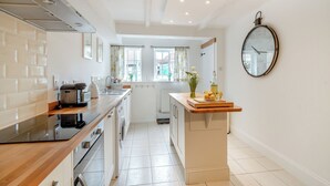 A modern kitchen with a built-in oven, a dishwasher, and a washing machine.