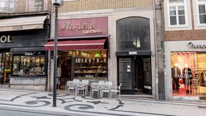 A building with multiple storefronts, including a cafe and a clothing store.