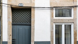 A building facade with a numbered door, a window, and a mail slot. - VIVA  Mosaics Studio (Porto)