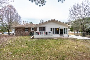 A single-story house with a brick exterior and a white front porch.