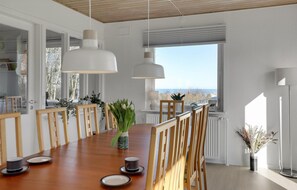 Enjoy meals in this dining area with a long table and comfortable seating for all.