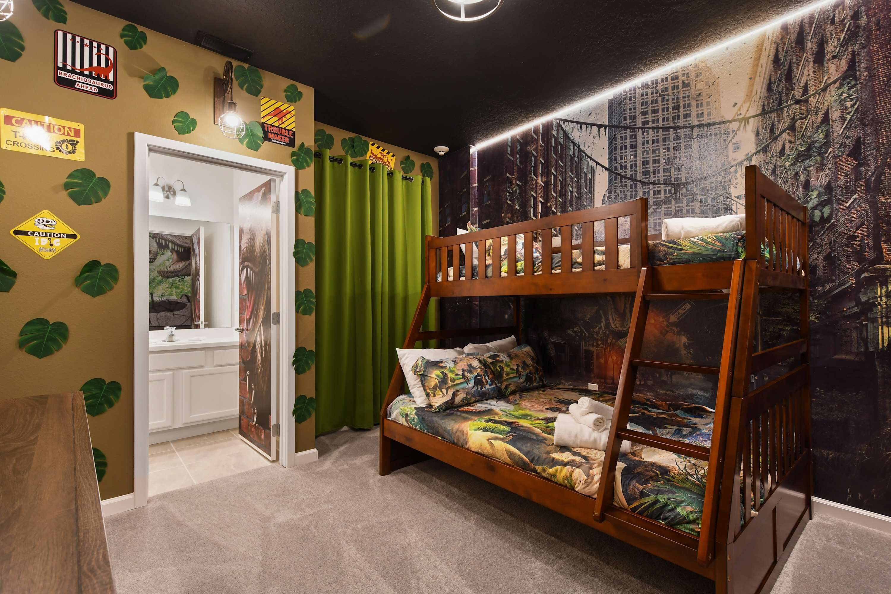 A bunk bed with a jungle-themed bedspread, a door with a mirror, and a wall with a cityscape mural.