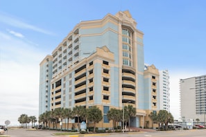 A multi-story hotel with a curved facade, balconies, and a sign indicating 'Holiday Inn Express.' - Pristine Condo Magnificent Ocean View, Lots of Upgrade, 11th Floor (Myrtle Beach)