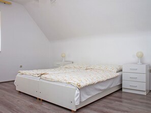 Un dormitorio con cama, mesita de noche y cómoda.