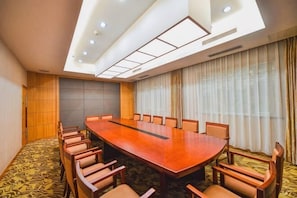 A conference room with a long table and chairs, a patterned carpet, and a large window with curtains. - Yangfang Dadu Hotel (Beijing)