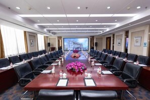 A conference room with a long table, chairs, and a projector screen. - Yangfang Dadu Hotel (Beijing)