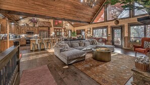 A spacious cabin interior with a large living area, a kitchen, and a dining area. - Luxe Mountain Retreat - Pet Friendly | Multiple Outdoor Living Areas | Hot Tub | Game Room (Blue Ridge)