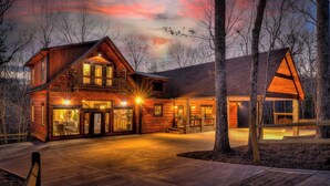 A two-story log cabin with a large front porch and a separate garage. - Luxe Mountain Retreat - Pet Friendly | Multiple Outdoor Living Areas | Hot Tub | Game Room (Blue Ridge)