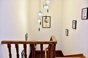 A staircase with wooden handrails and a wall adorned with framed pictures.