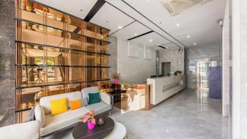 Espaço moderno com sofá, mesa de jantar e área de cozinha.