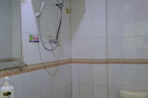 A bathroom with white tiled walls, a shower with a handheld hose, and a toilet with a paper towel dispenser. - Pearl Hotel (Nanxing Second Road) (Zhaoqing)