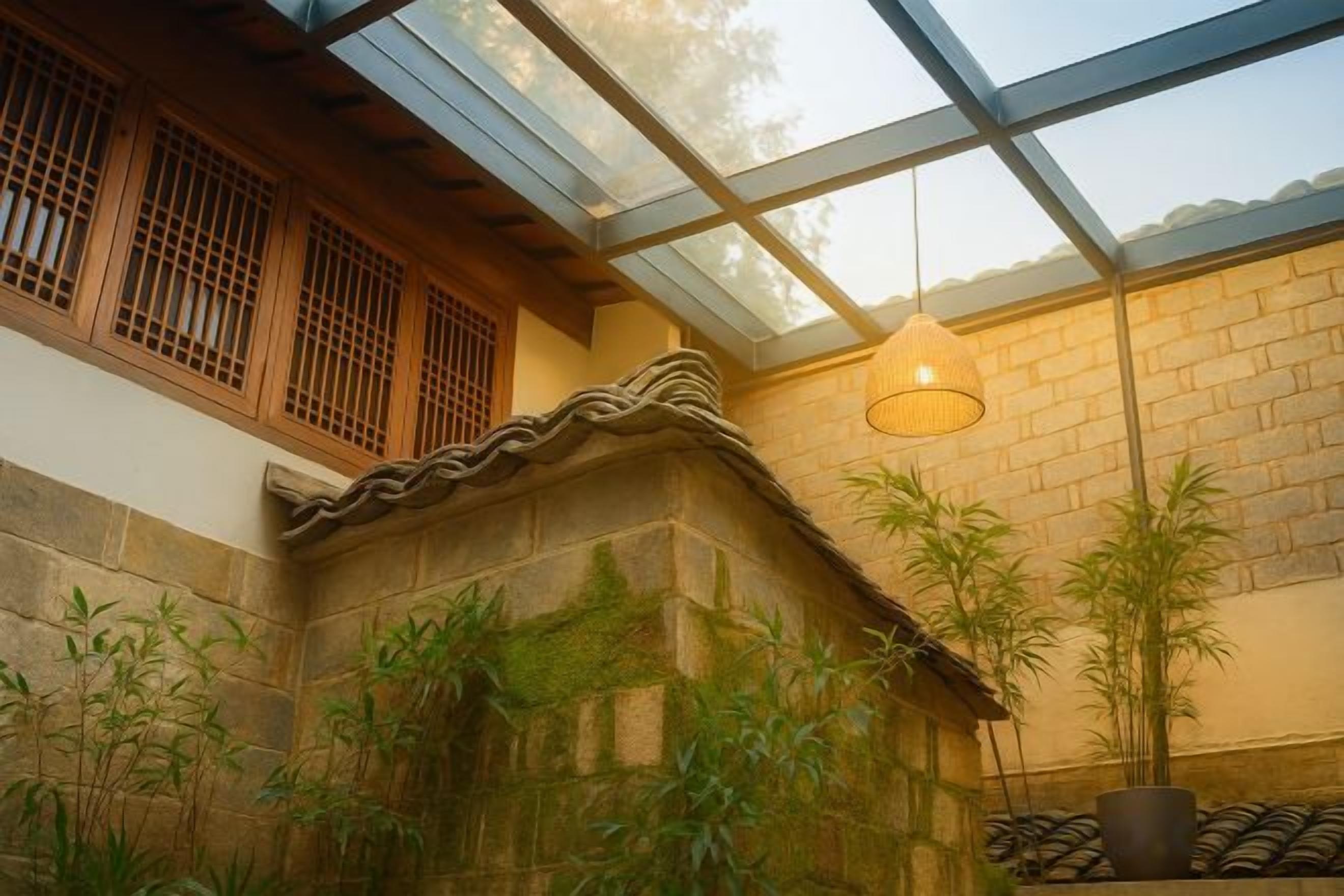 A traditional building with a stone wall, wooden window frames, and a glass ceiling.