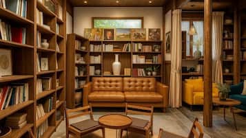 A cozy library with a leather sofa, wooden bookshelves, and a round coffee table.