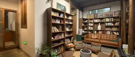 A library with bookshelves, a sofa, and a reading area.