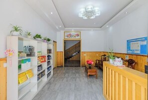 Welcome to our reception area, featuring a reception desk, shelving unit, and staircase.