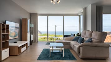 Royal Apartment, 3 Bedroom, Patio, Ocean View | Living area | 50-inch flat-screen TV with cable channels, TV