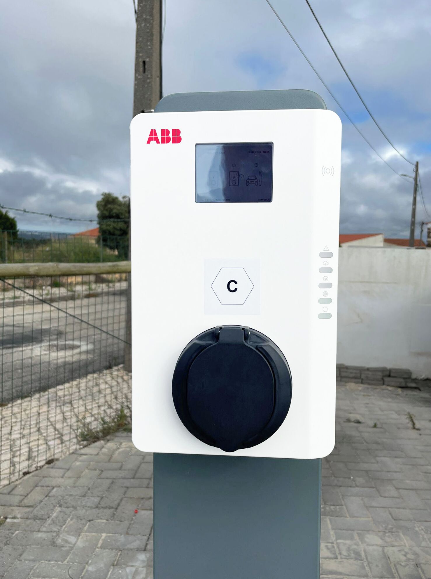 A portable ABB electrical box with a digital display, a control button, and a charging port.