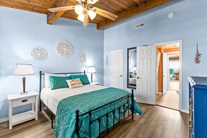 Cozy retreat with a plush bed, bedside tables, and decorative wall art.