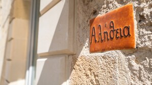A sign with the name 'Andrea' on a textured wall.