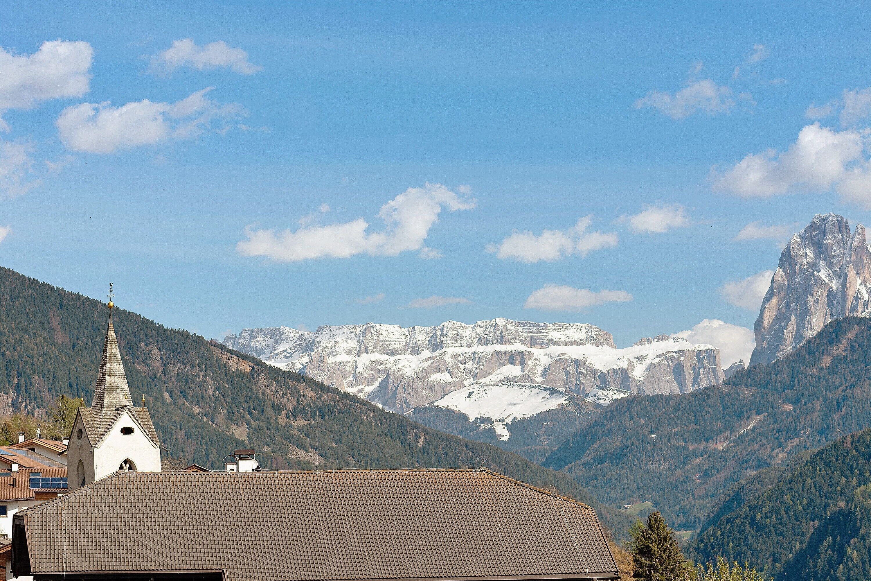 A mountain landscape with a church and a mountain peak.