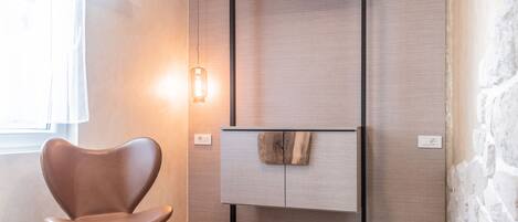 A modern room with a wooden cabinet, a brown leather chair, and a small table.